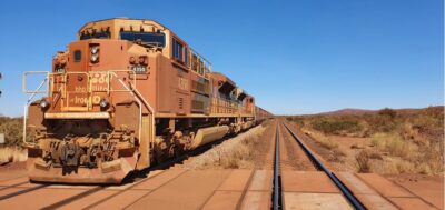 BHP Mining Haulage Train in the Pilbara with red dirt and clear blue sky