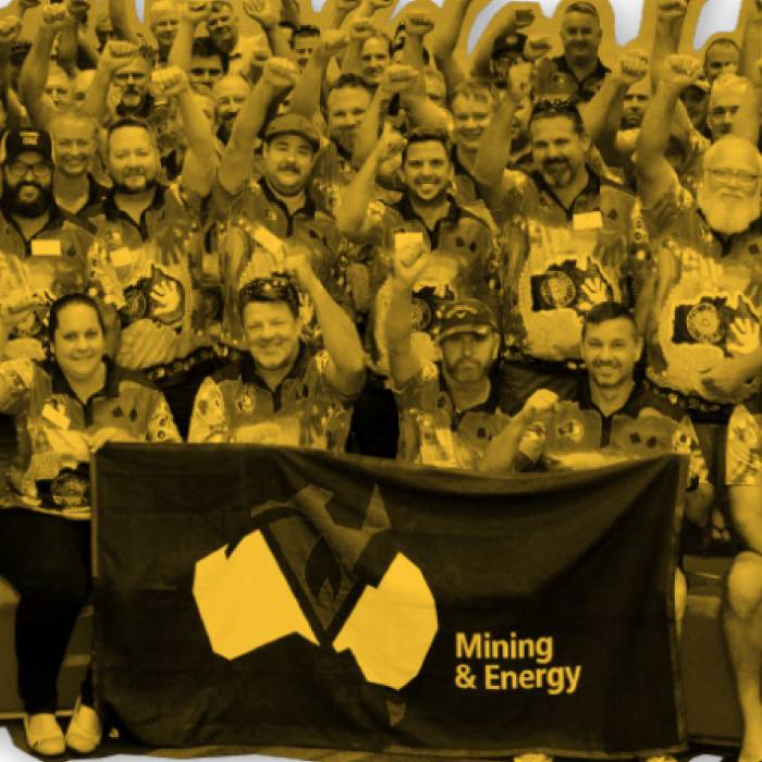 MEU members standing behind a MEU flag