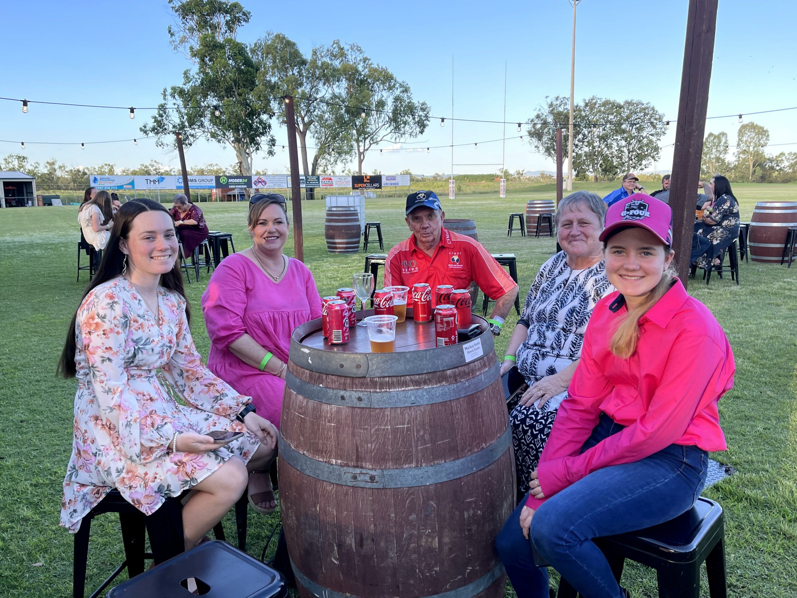 4 people smiling and enjoying a drink