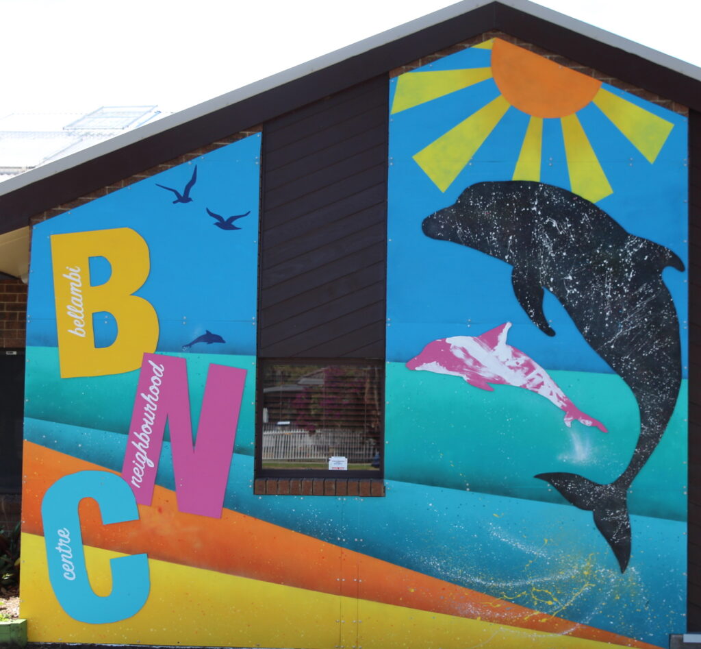 Mural on the side of the wall of the Bellambi Neighbourhood Centre that features three dolphins jumping out of the sea and 2 seagulls