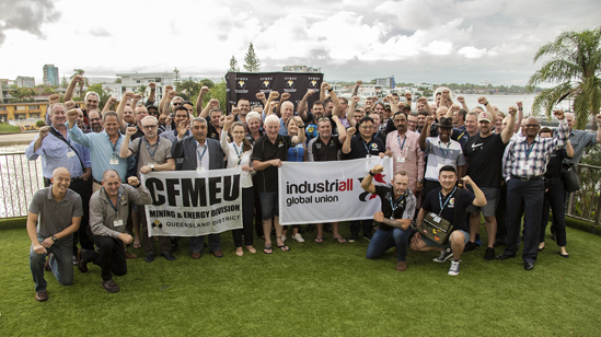 People standing behind flag that says 'cut the dust'