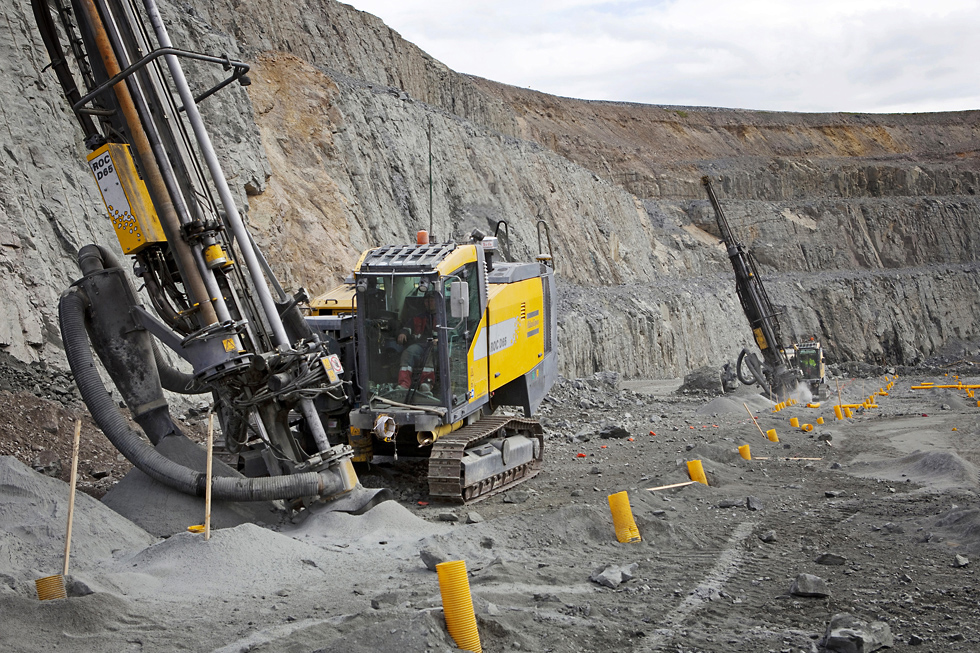 Mining drill in an open cut mine operated by a miner.
