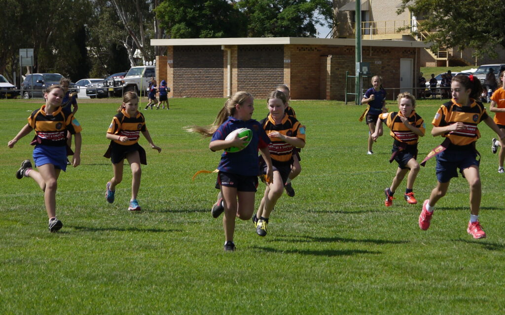 Young girls playing rugby league at the coalminers cup carnival
