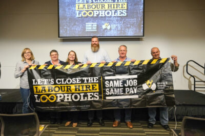 A group of MEU representatives holding a banner that reads: "Lets close the labour hire loopholes. Same job same pay."