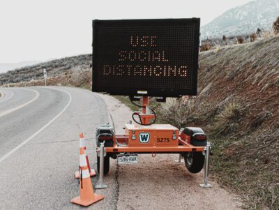 Temporary led Road sign that reads 'use social distancing'