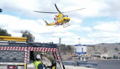 A Westpac medevac helicopter hovering above a mine site.