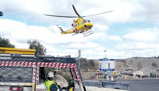 A Westpac medevac helicopter hovering above a mine site.