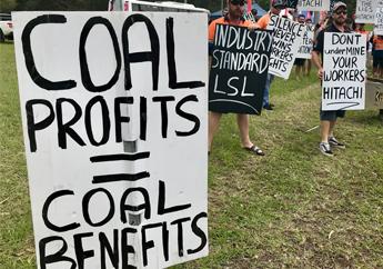 Picket sign that reads 'COAL PROFITS = COAL BENEFITS'