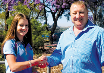 Jeff Drayton shaking hands with a school student